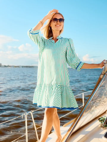 The "Naomi Dress" features a striped design with a ruffle V-neckline. Available sizes: XS, S, M, L, XL.