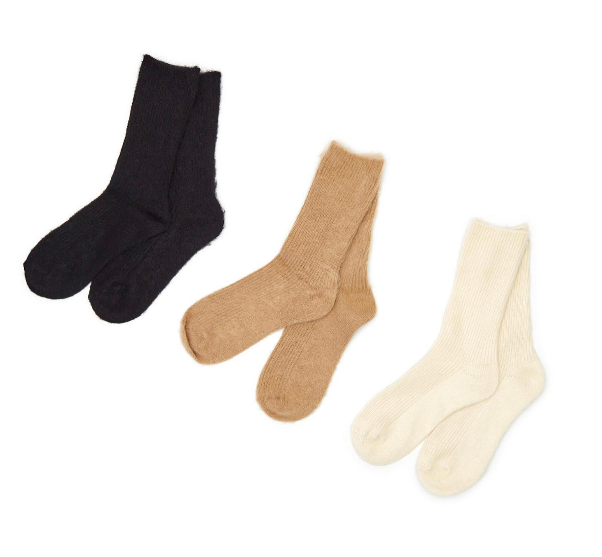 Three pairs of Cashmere Socks in black, light brown, and cream. Available in sizes S, M, and L.