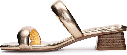 The Alistair Heels - Metallic Gold are chic open-toe sandals with wide metallic straps and a low chunky block heel. Available sizes: 5-11.