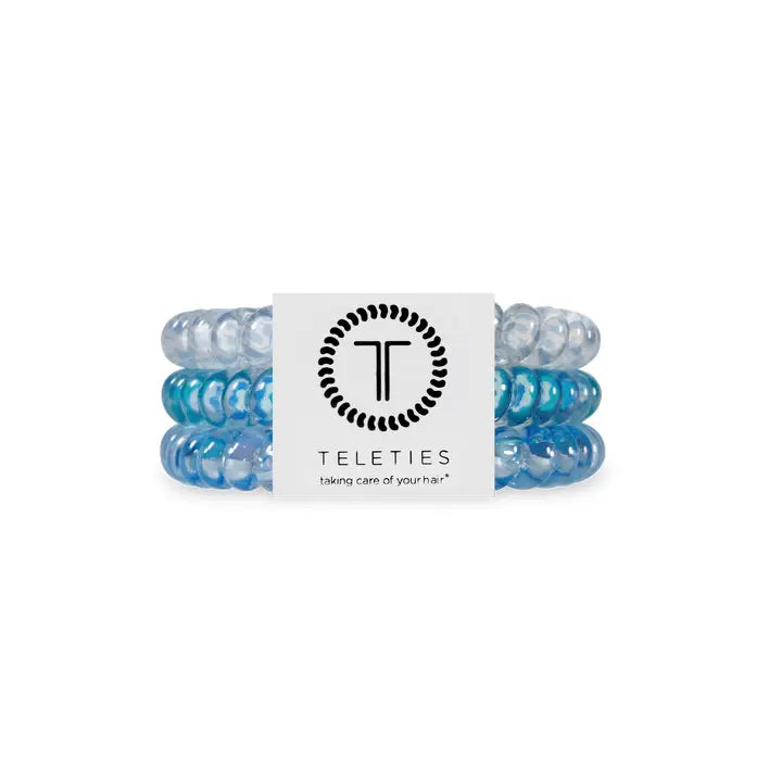 Three blue and clear TELETIES hair ties, white label with logo. Available in small, medium, large sizes.
