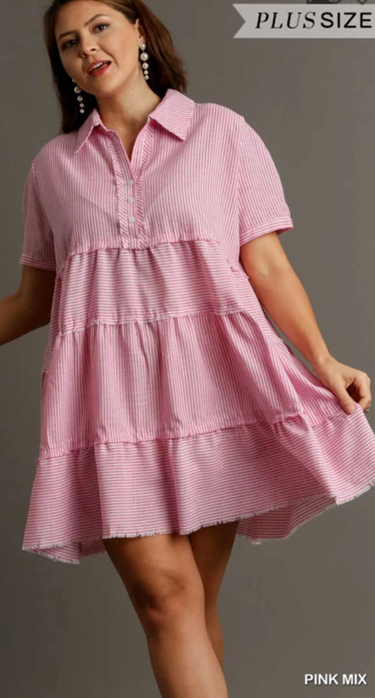 This is a plus size strapped dress with two tears, short sleeve button neck with a collar. It comes in pink and white and two in white.