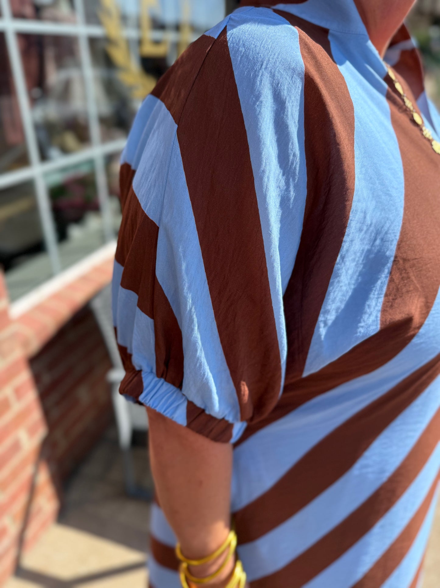 Riverwood Stripe Midi Dress with blue and brown stripes and puffed sleeves; available in sizes XS–XL.