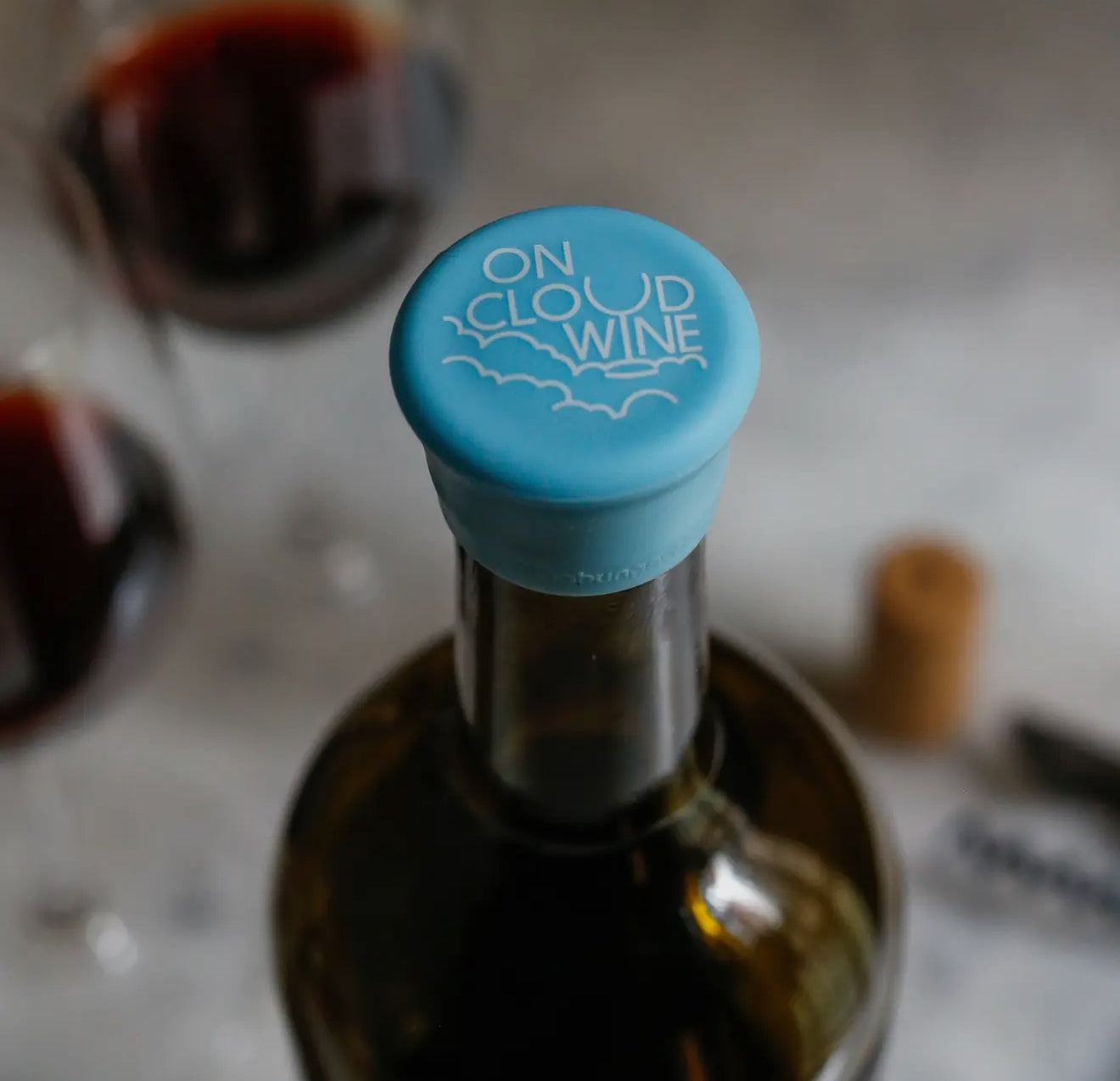 Blue Wine Cap bottle stopper with "On Cloud Wine" and cloud design; available in standard wine bottle size.