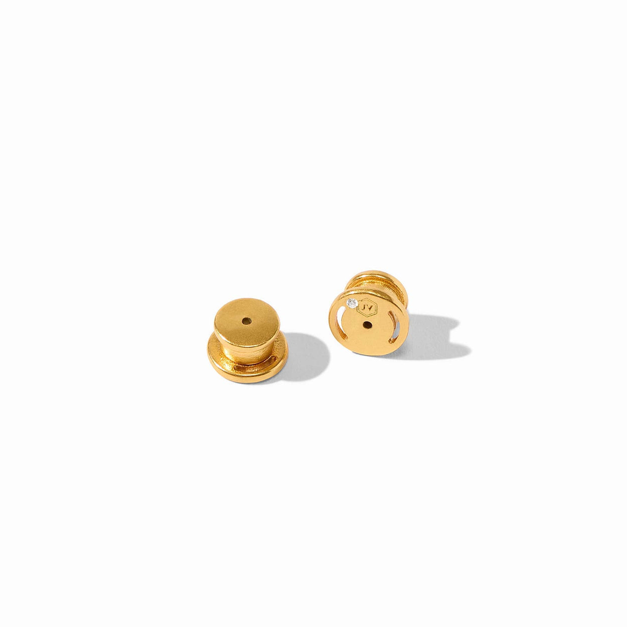 Small, round gold-plated earring backs with subtle stamped marking; available in one size.
