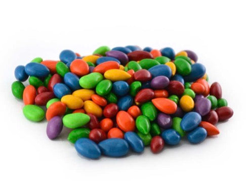 Chocolate sunflower seeds coated in rainbow colors (blue, green, yellow, orange, red, purple); available in assorted sizes.