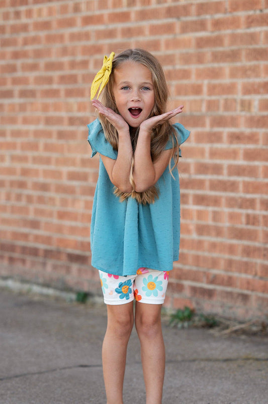 Girls Happy Flower Short Set: teal swiss dot flutter sleeve top, retro smiley daisy print shorts. Sizes 2T–8 available.