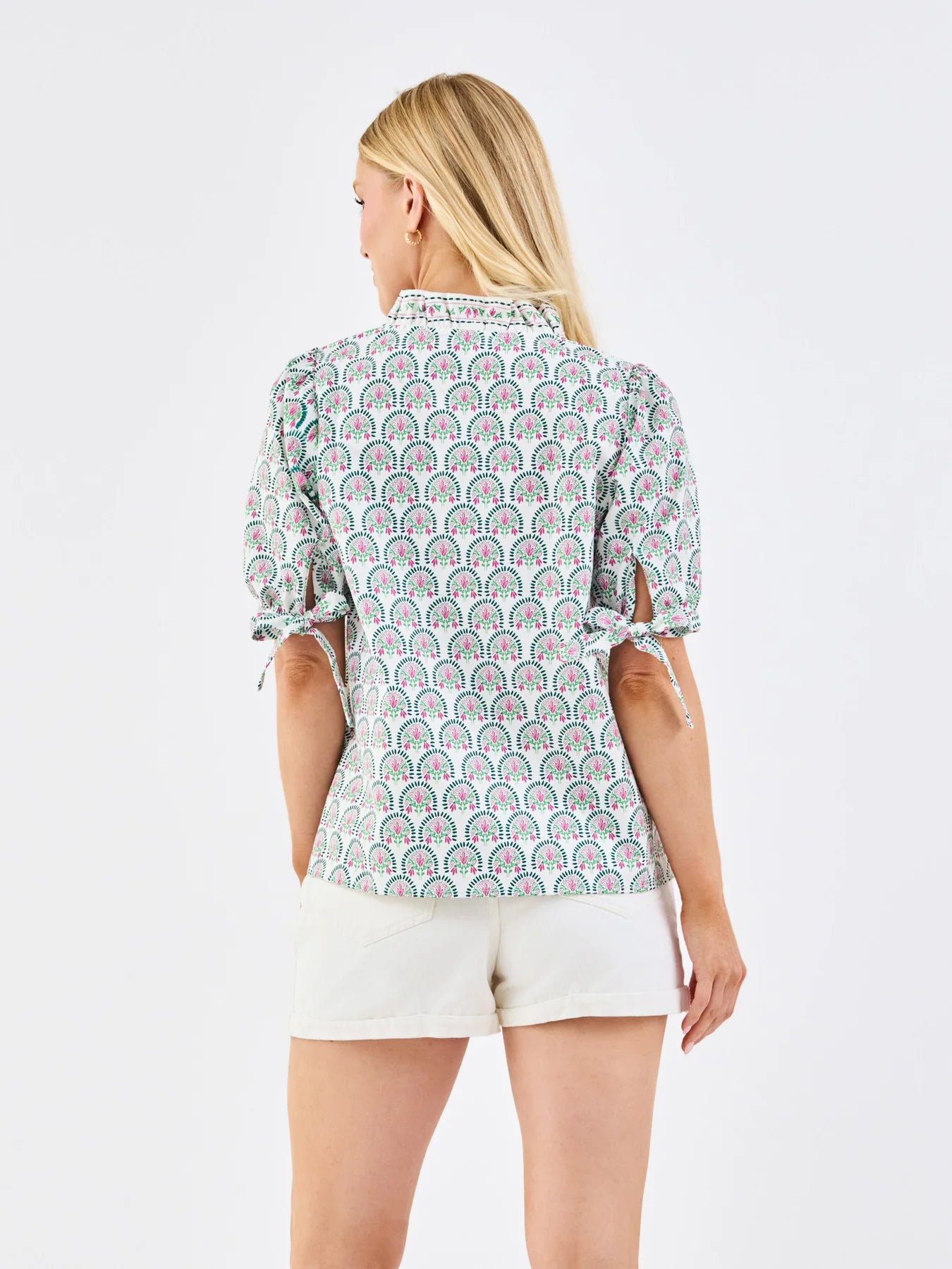 Brynn Sunshower Flora White Top with puff sleeves and ruffle mock neckline. Available in sizes XS–XL.