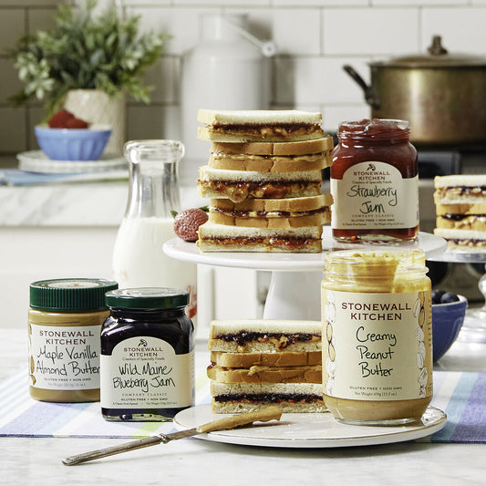 Mini Jam 3.75oz jars in raspberry peach champagne, strawberry, and blueberry flavors are displayed.