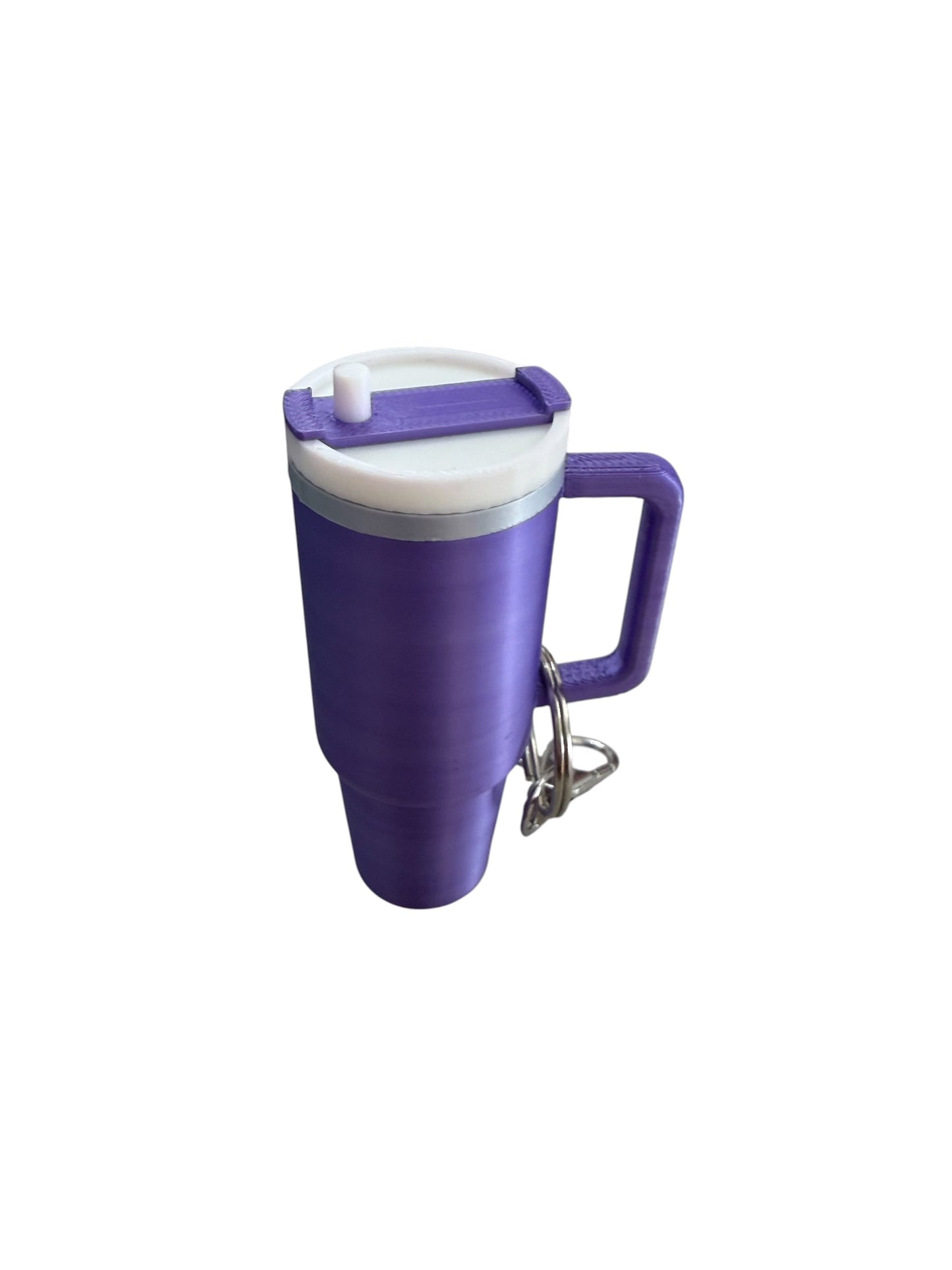 The Keychain Cup is a purple plastic travel mug with a white lid, matching purple handle, and attached metal keychain. Available in 12oz and 16oz sizes.