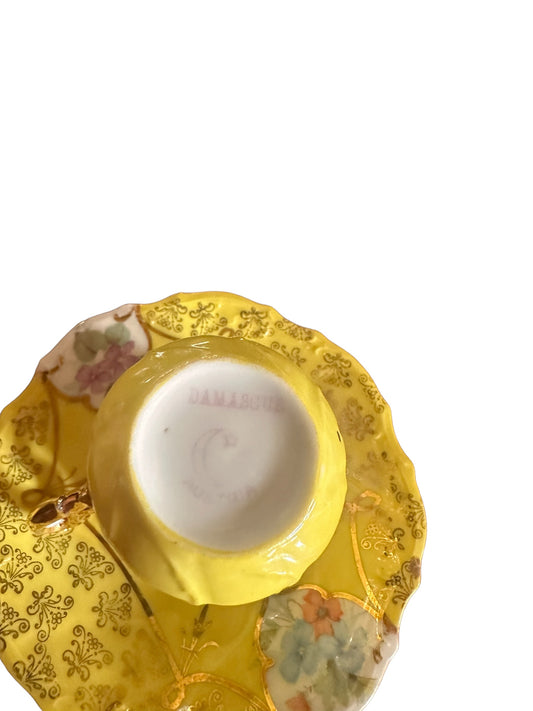 Antique yellow demitasse cup and saucer with floral, gold accents; "DAMASQUIN" on base. Available in demitasse size.