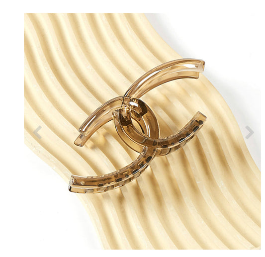 The Link Hair Clip: translucent brown, glossy, curved abstract design, 3.9-inch size available.