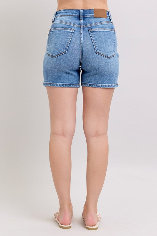 Judy Blue Mid Length Dad Shorts in light blue with back pockets. Available in sizes S-XL.