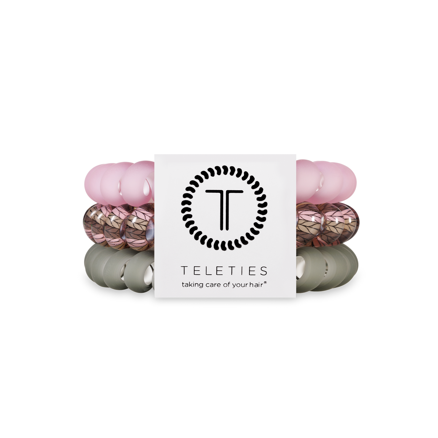 Three TELETIES Hair Ties in pink, leaf-patterned, and olive; available in small, medium, and large sizes.