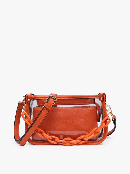 The Jessica Clear Crossbody is a small rectangular orange purse featuring a transparent body, vegan leather accents, front pocket, adjustable strap, and chunky orange chain. Available size: 8"L x 6"H x 2.5"D.