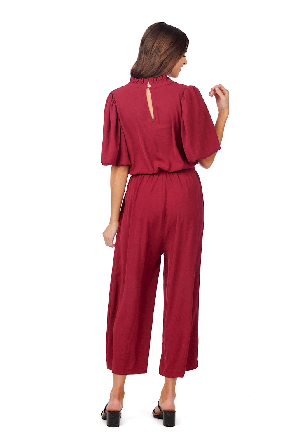 Annalise Jumpsuit: loose-fit polyester, short sleeves, back keyhole, removable waist tie. Available in sizes XS-XL.
