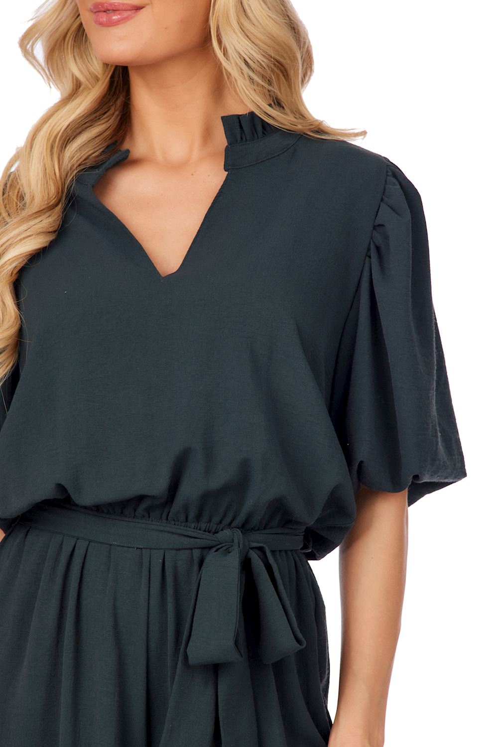 Annalise Jumpsuit in dark green with ruffle collar, v-neckline, short sleeves, removable waist tie. Available in sizes XS-XL.