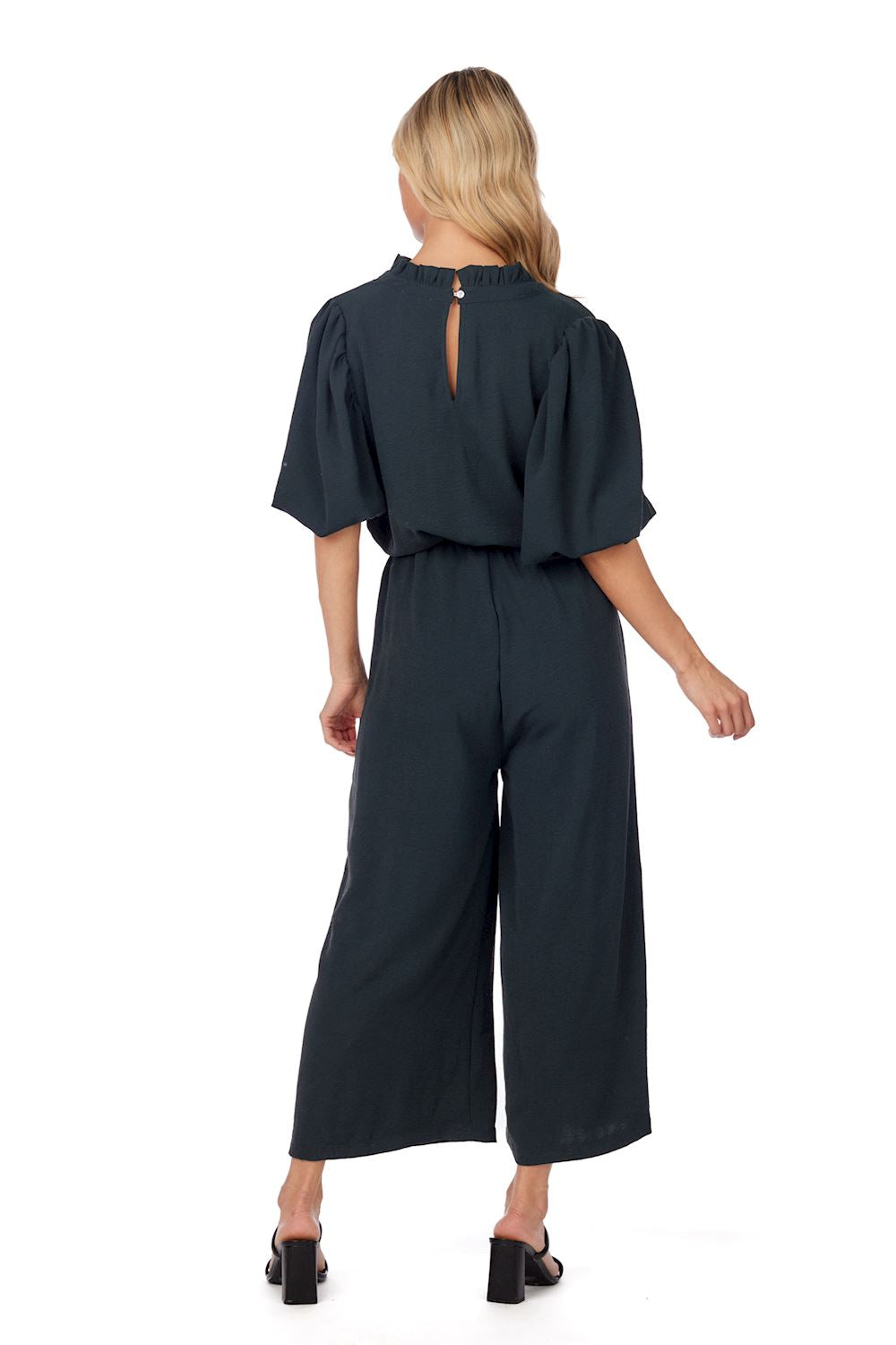 Annalise Jumpsuit—dark green polyester, wide legs, keyhole back, removable waist tie. Available in sizes XS–XL.
