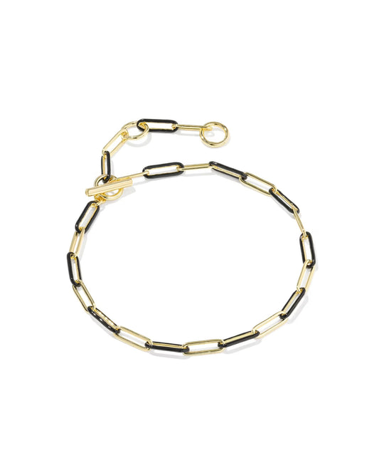 Delicate gold chain bracelet with elongated links, black enamel accents, adjustable clasp; available in multiple sizes.