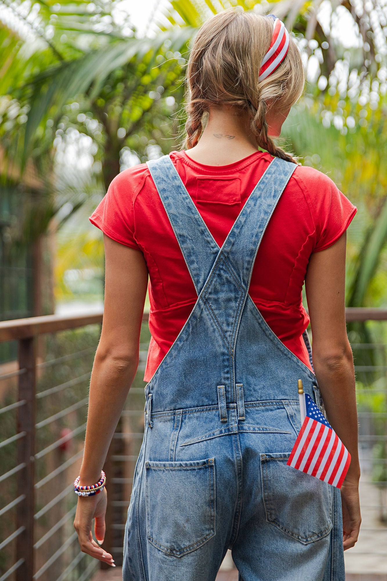Dakota Mineral Wash Denim Jumpsuit in blue, features front buttons and pockets; available in sizes XS-XL.