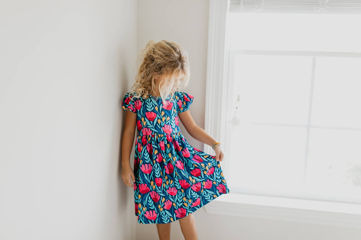 Kids Blue Floral Flutter Sleeve Dress with colorful floral print. Available in sizes 2T-10Y.