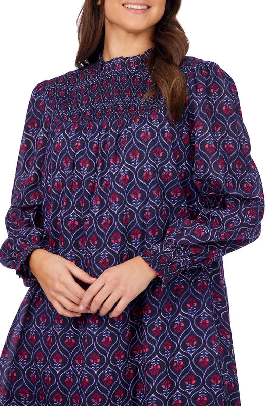 Navy Block Print Bennington Smocked Dress with long sleeves, high smocked neck, cuffs, geometric and floral print. Sizes XS-XL.