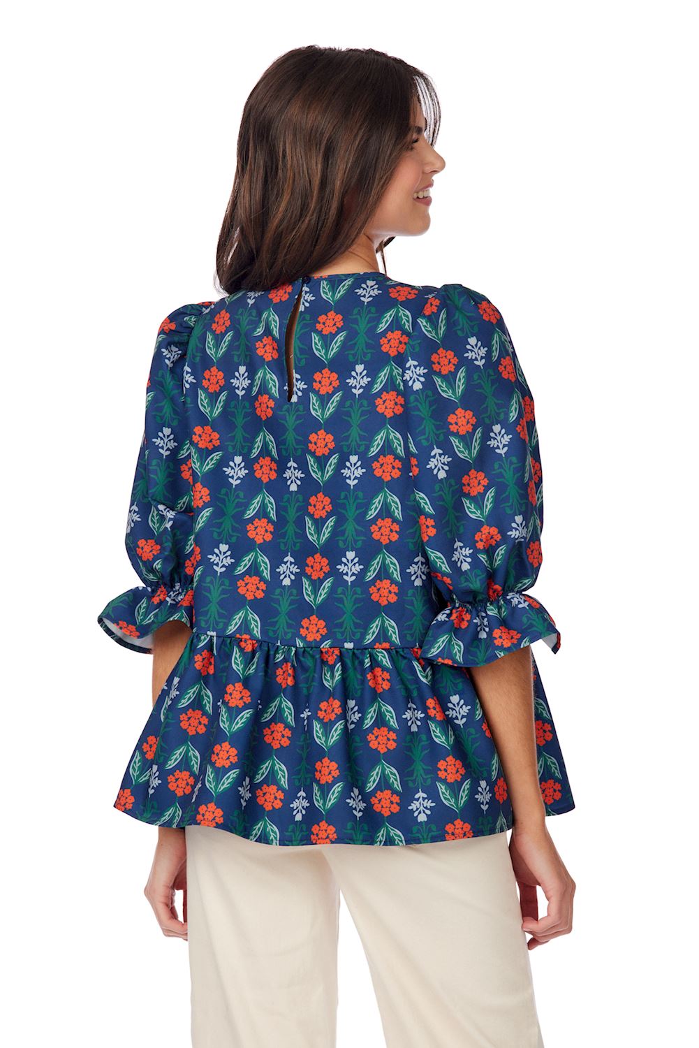 Navy Floral Pierce Flounce Top with ruffled sleeves, peplum waist, colorful floral print. Available in XS–XL.