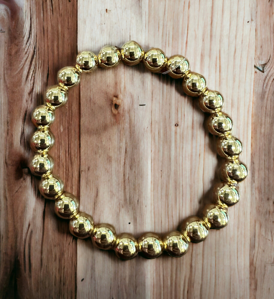 Gold stainless steel beaded bracelet, available in 6, 7, and 8 inches. Features polished round beads.