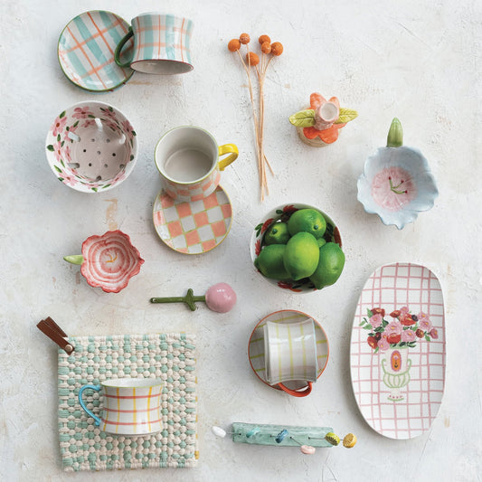 8 oz hand-painted stoneware mug with floral and checkered patterns. Available size: 8 oz.