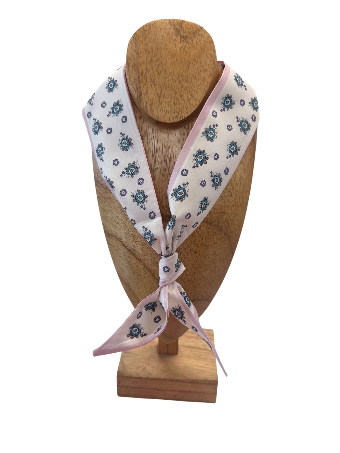 The Scarf Necklace features pale pink fabric with blue floral patterns, tied in a simple knot. Available in S, M, L.