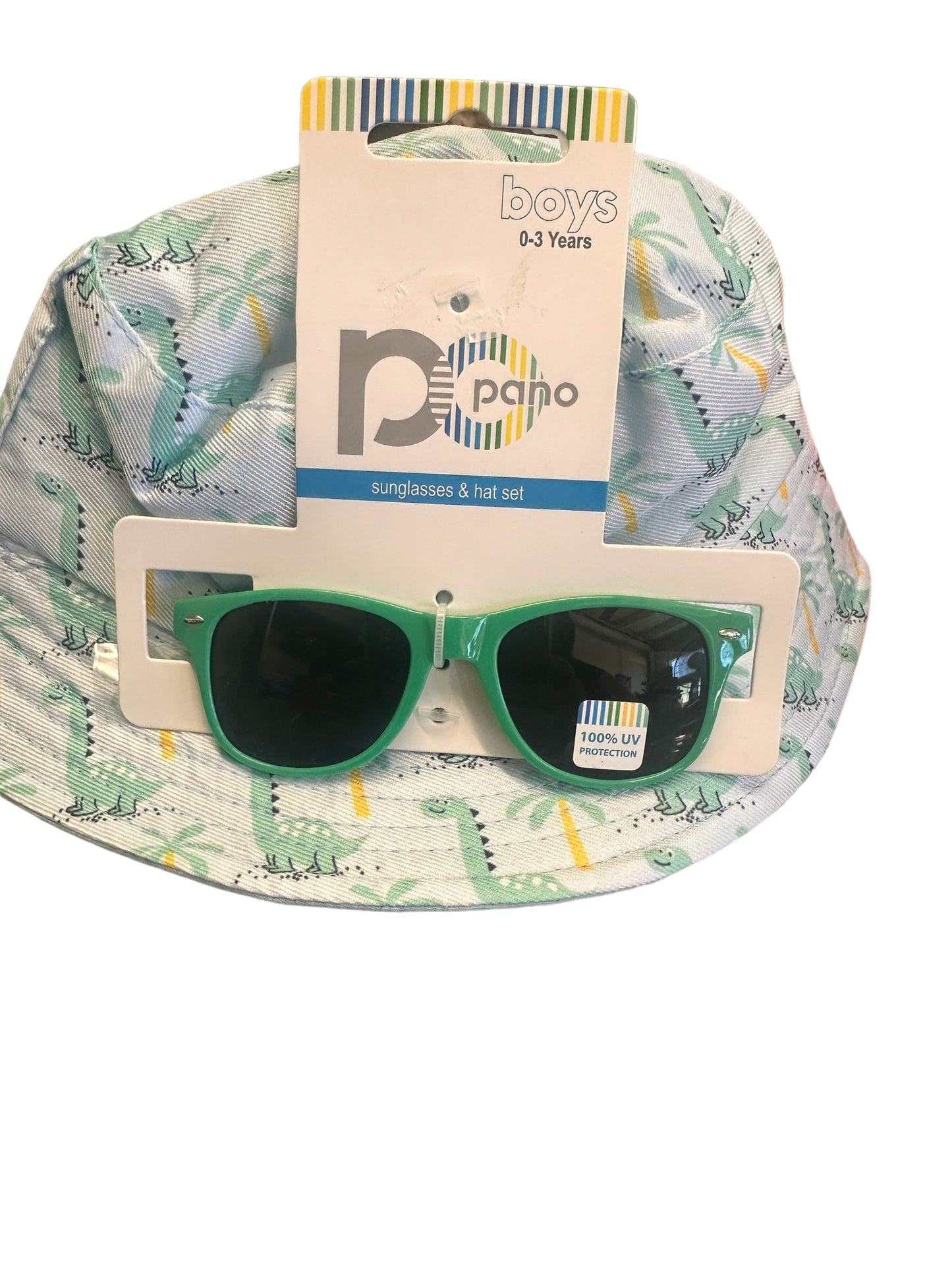 Baby boy's hat and sunglasses set for ages 0-3 years. Hat: light green with dinosaur pattern. Sunglasses: green-rimmed, UV400 protection. Packaged together. Sizes available: One size fits most (0-3 years).