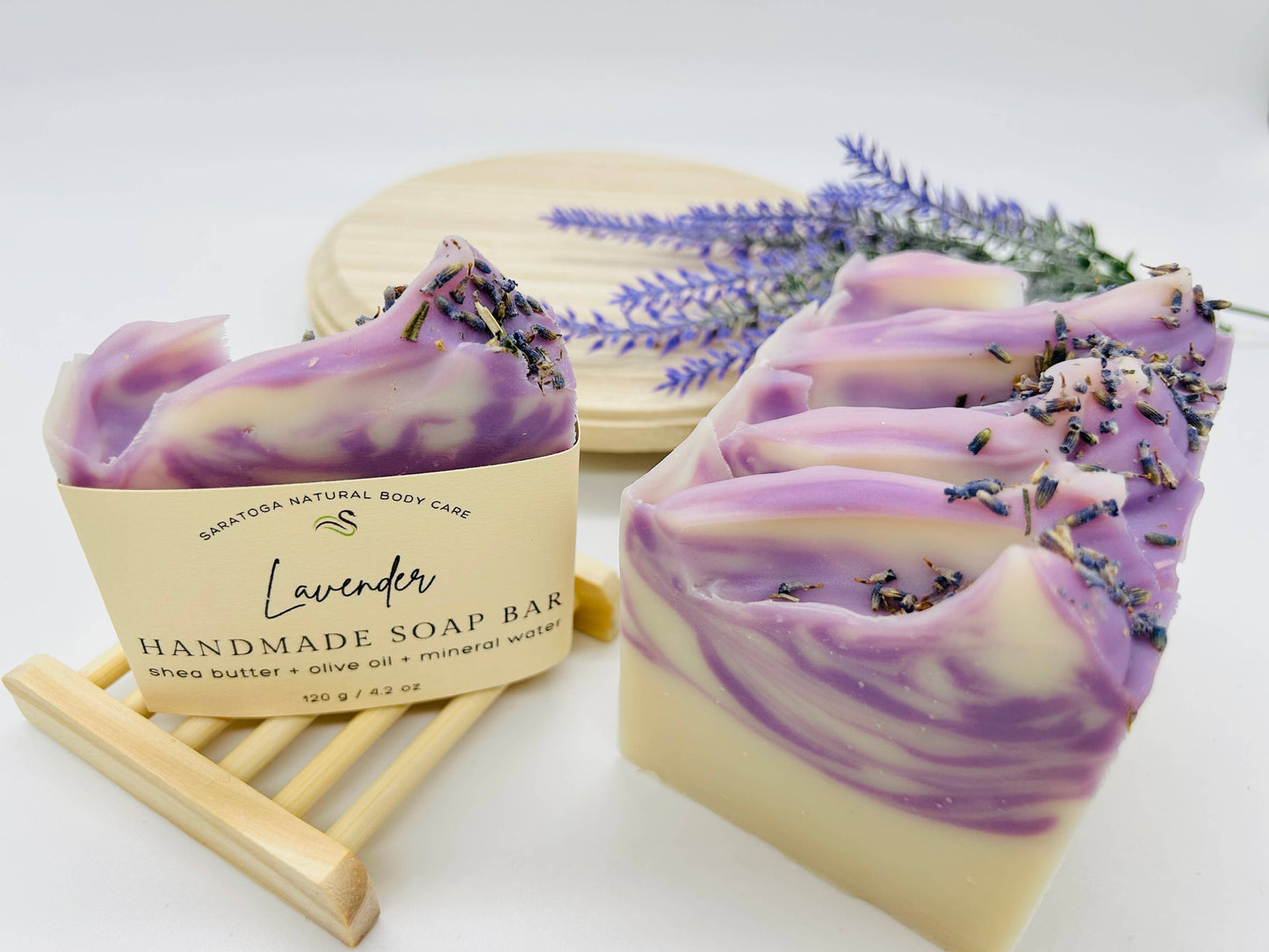 Handmade vegan cold process soap bars scented with lavender. Enriched with dried lavender on top. Comes in a set of three bars. No size variations available. Small wooden soap dish not included.