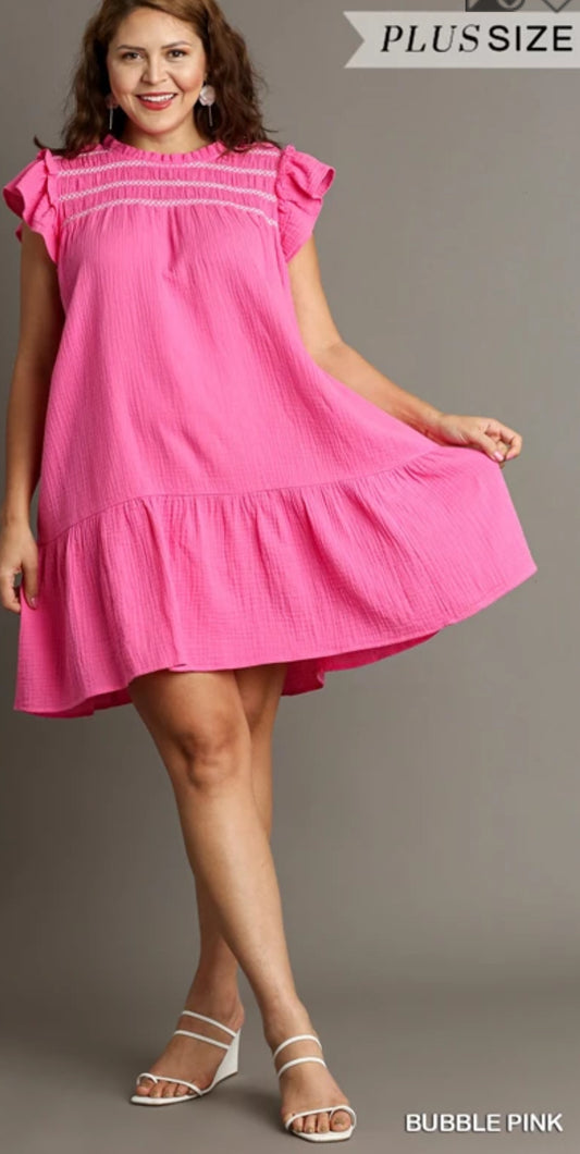 This pink sleeveless dress with white contrasting stitching hundred percent cotton.