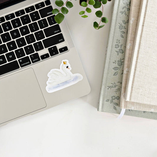 Watercolor swan vinyl sticker by Emily Lex displayed on a laptop. Sizes available: small, medium, large.