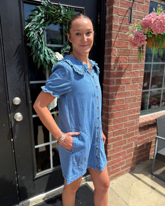 Denim Ruffle Collar Mini Dress featuring a ruffled collar and pockets; available in sizes XS–XL.