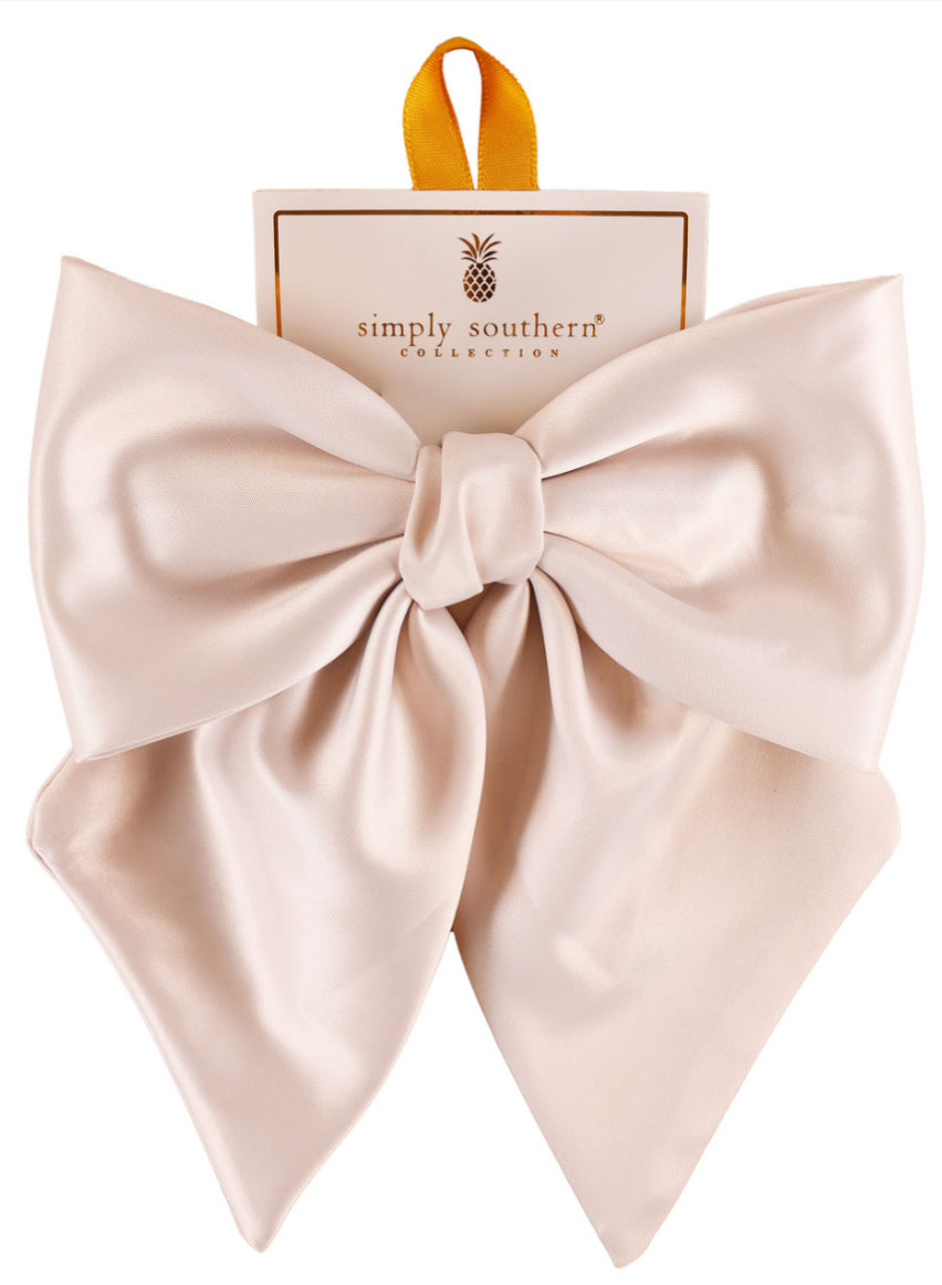 Large pale pink satin bow on “Simply Southern Collection” card with yellow hanging loop; available in large size.