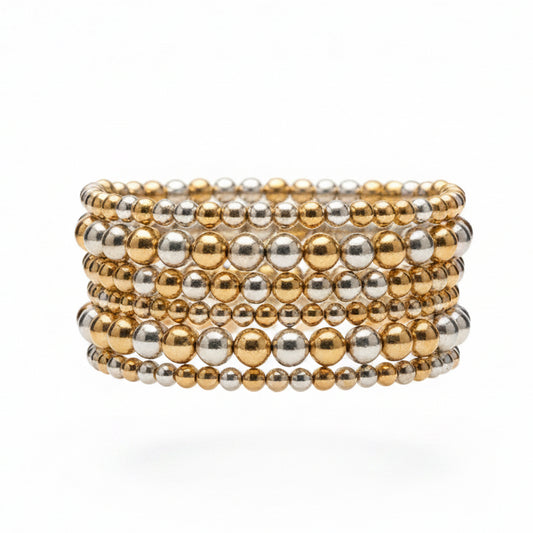 The Hunter 6-Strand Stretch Bracelet Stack features alternating gold and silver metallic beads in varying sizes, creating a wide stack. Available in one size fits most.