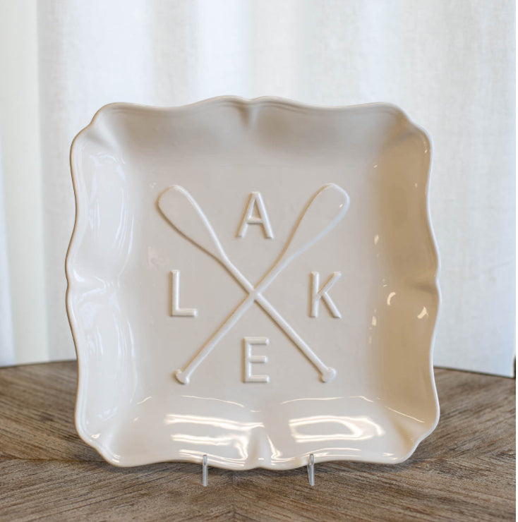 Cream ceramic platter with scalloped edges, crossed oars, letters "A L K E", 11.5" size.