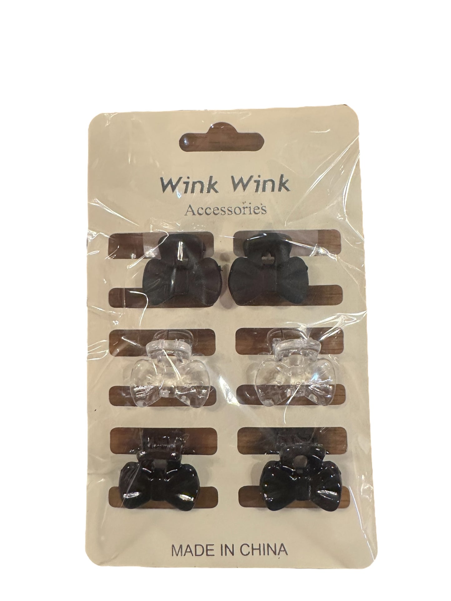 Six small black and clear bow-shaped hair clips, labeled "Mini Bow Hair Clip Sets." Sizes unavailable. Made in China.