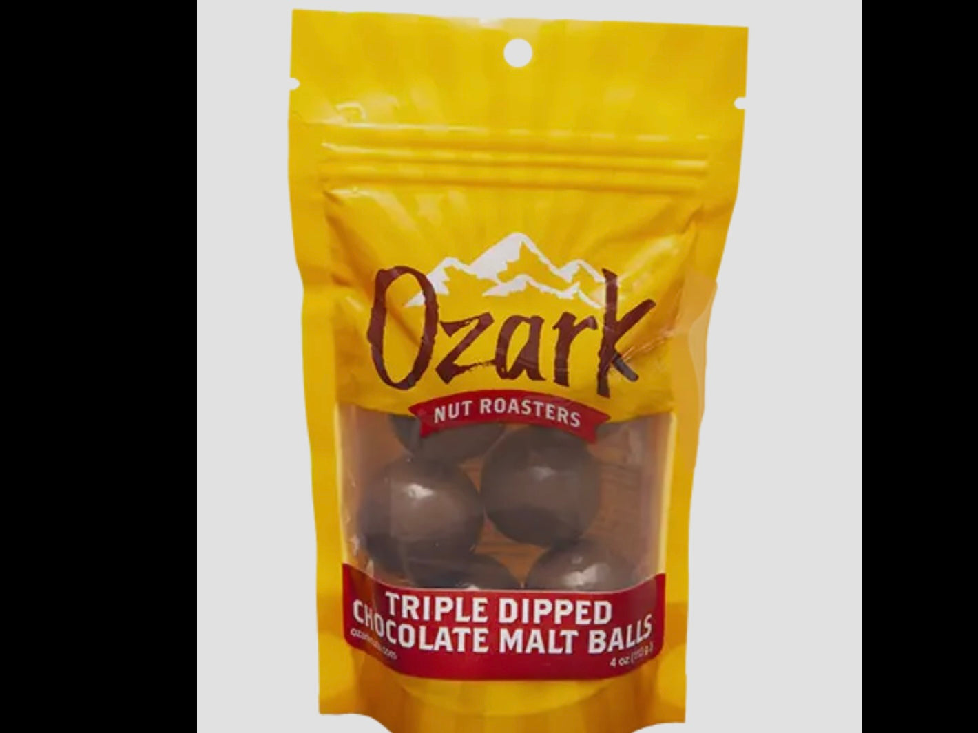 Yellow 3.5oz bag of Ozark Nut Roasters Chocolate Triple Dipped Malt Balls, with round chocolate-coated treats visible inside.