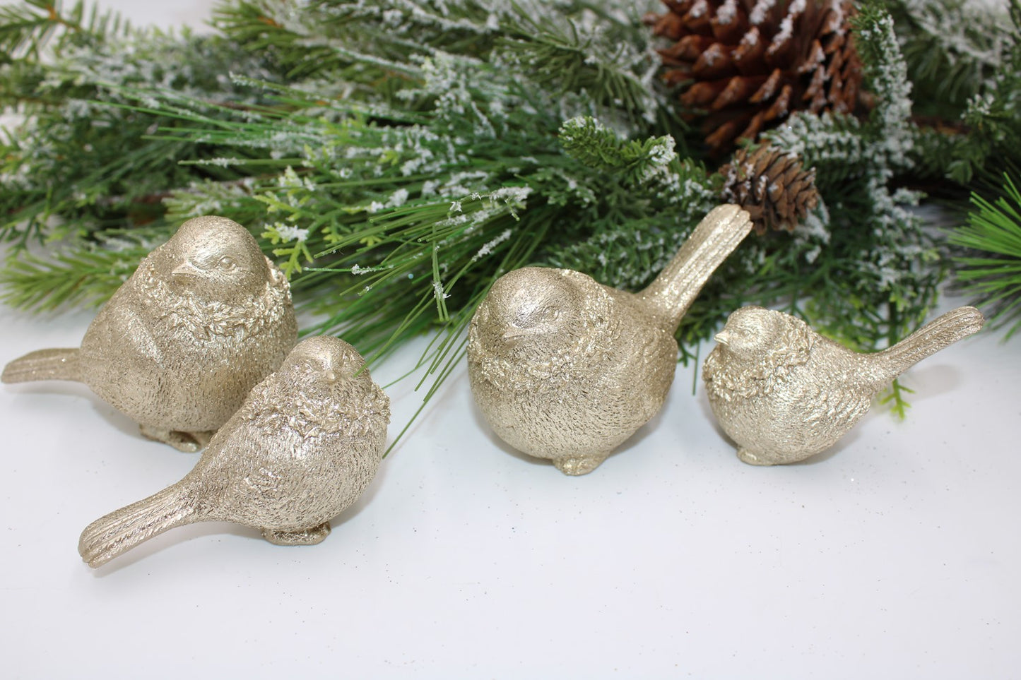 Set of four gold resin birds; available in small (3”), medium (4”), and large (5”) sizes.