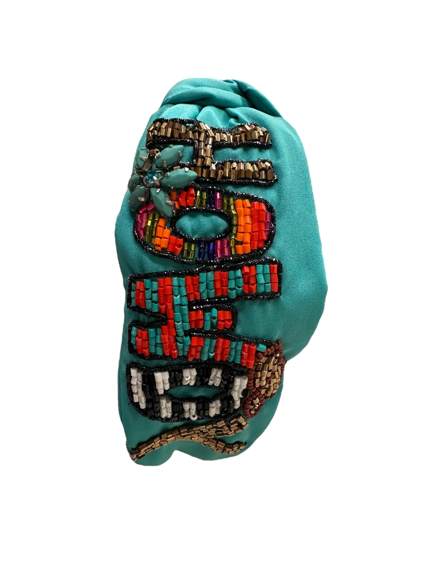 Brightly colored beaded hairband with a turquoise fabric base. Features beads in red, orange, black, white, and metallic tones in intricate patterns. Available sizes: One Size.