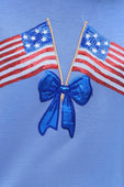 Two small American flags cross above a shiny blue ribbon bow. Liberty Bow Flags Luxe Top available in S, M, L, XL sizes.