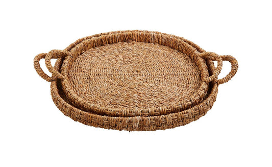 Two seagrass basket trays with handles, rustic texture, raised edges; available in small and large sizes.