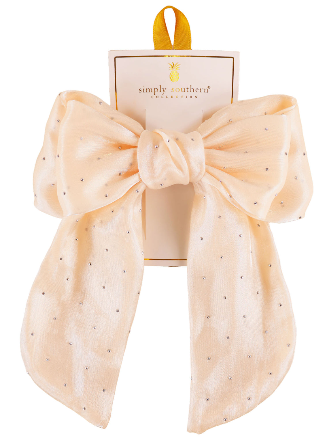 Large pale peach hair bow with silver dots on Simply Southern card; yellow loop; available in large size.