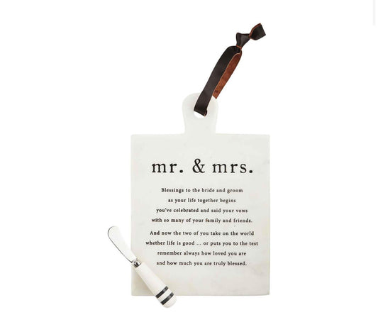 Mr. and Mrs. blessing board it is a marble board with a leather holder running through a hole at the top and it includes a spreader trimmed and white marble and black stripes. Reads Mr. and Mrs. blessings to the bride and groom as your life together begins you've created and said your vows with so many of your family and friends and now the two of you take on the world whether life is good or put you to the test remember always how loved you are and how much you are truly blessed