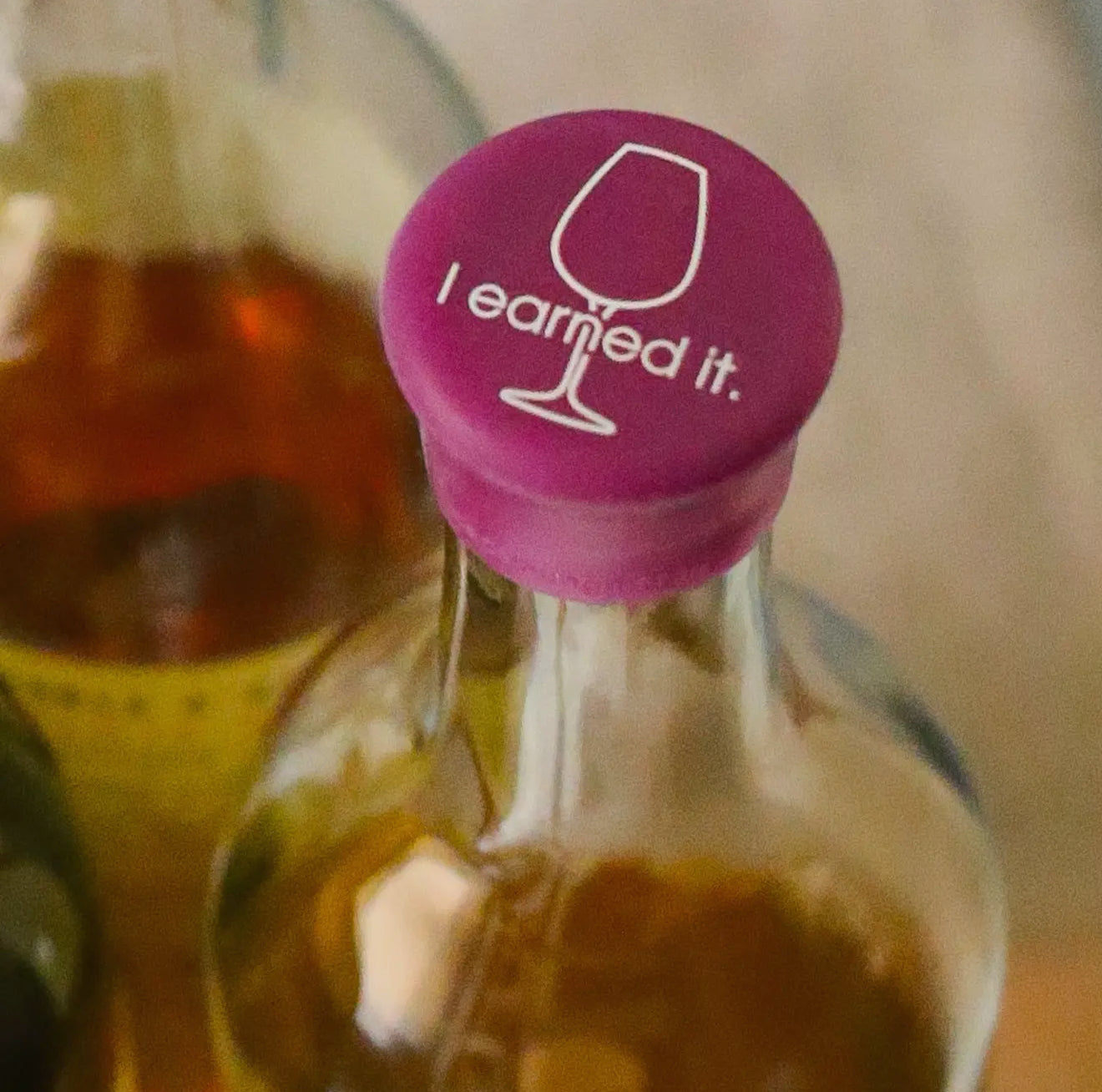 Purple Wine Cap with wine glass graphic and "I earned it" phrase. Available in sizes S, M, and L.
