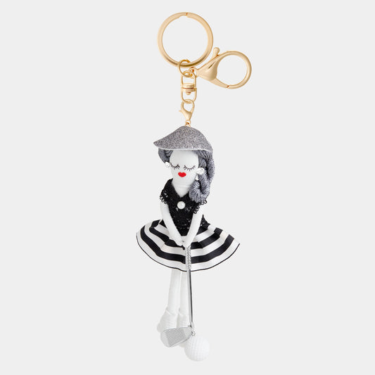 Black and white fabric doll key fob with golf club, ball, gold clips. Available in one size.