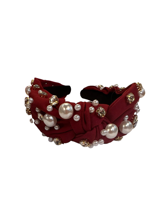 Deep red satin headband with front knot, faux pearls, gold-tone jewels; wide design. Available in one size.