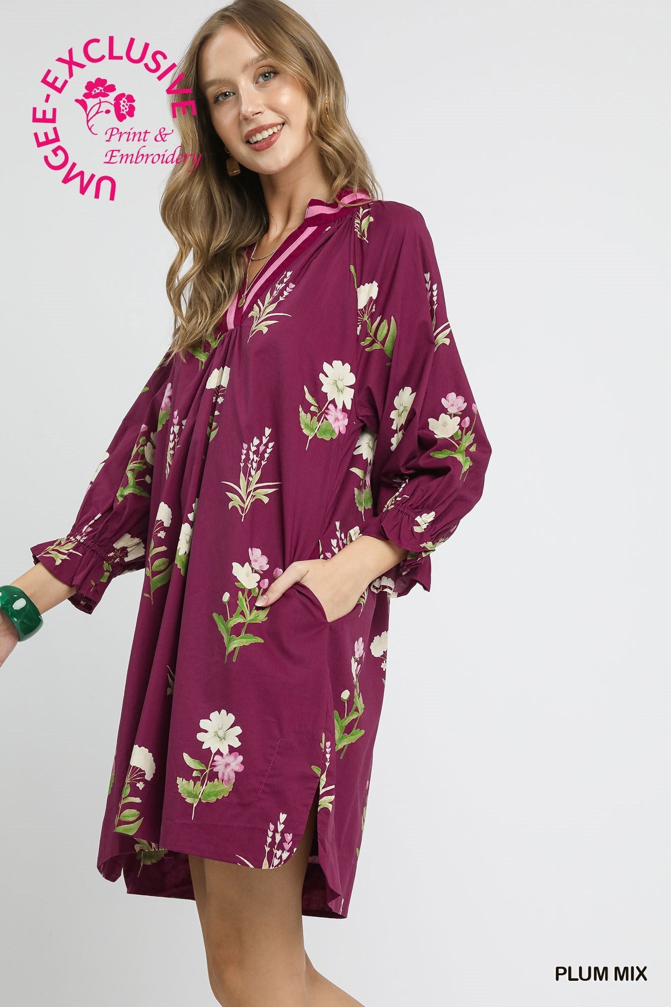 Loose, long-sleeve floral tunic dress with contrast trim in plum mix, white/pink print. Sizes: XS–XL.