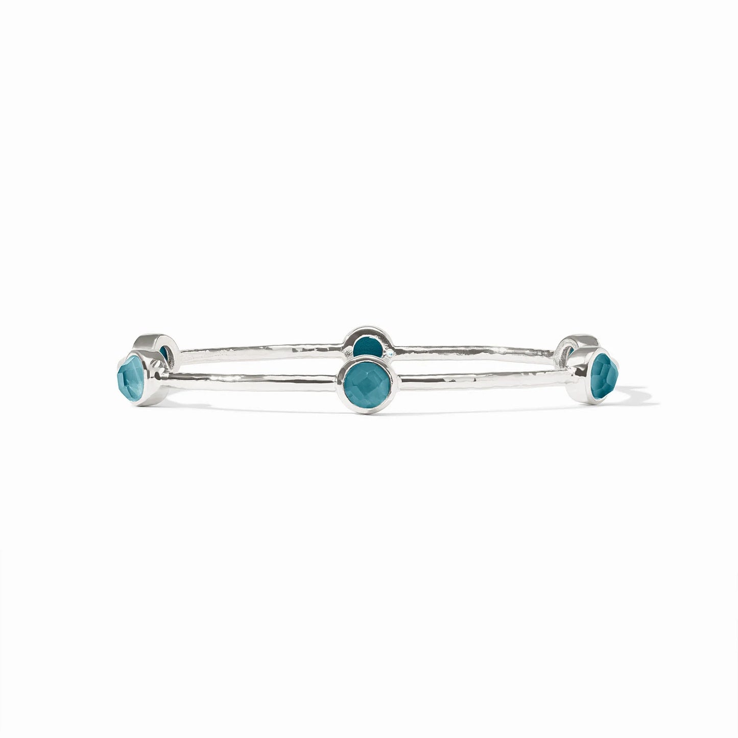 Silver bangle with five round blue bezel-set stones. Available in small, medium, and large sizes.